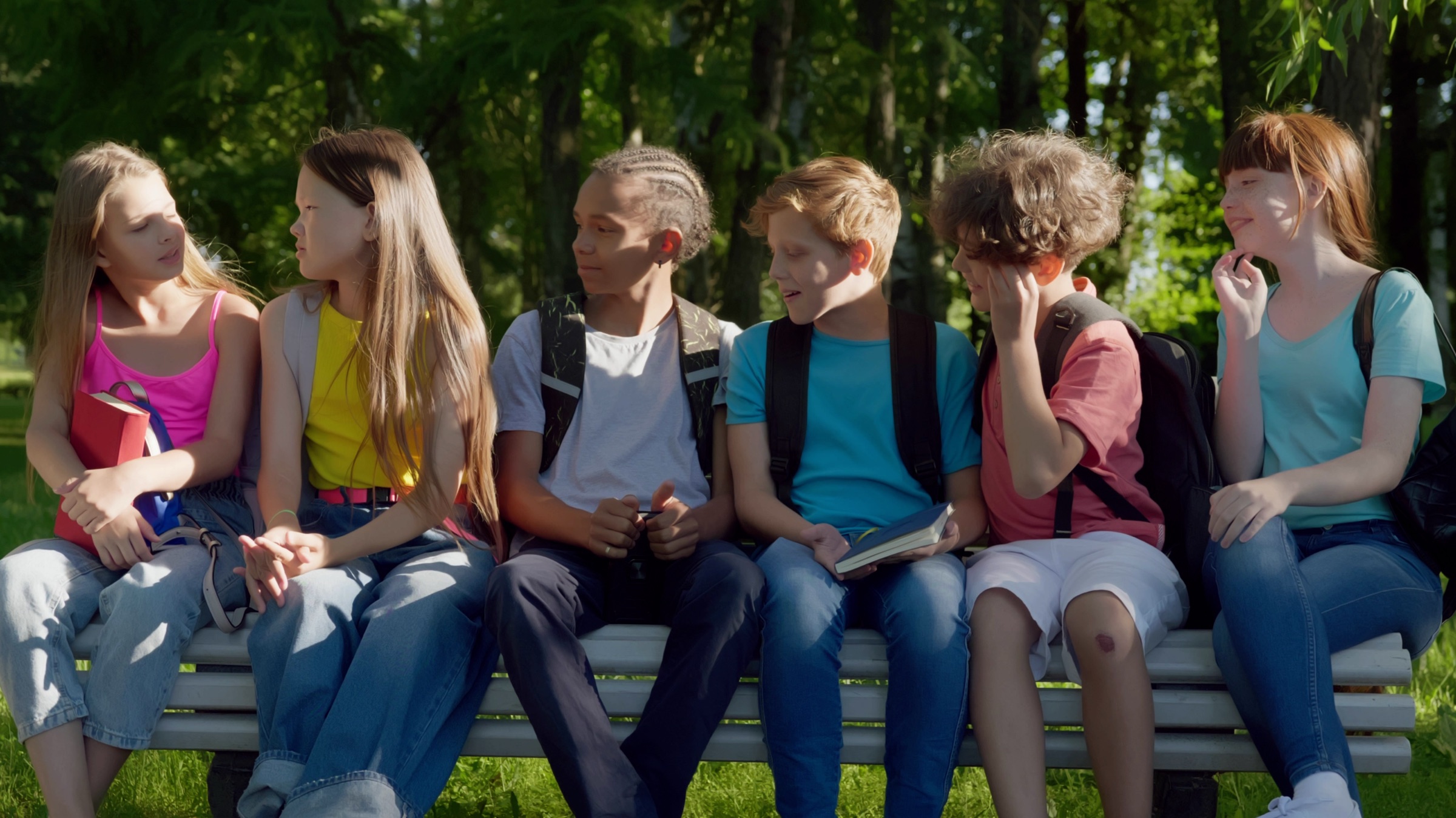 A group of happy primary-school children sitting together outside